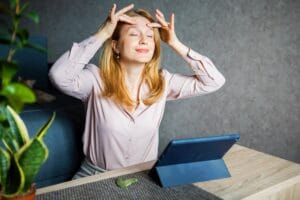 Kobieta stosuje masaż twarzy jako naturalne sposoby na stres.