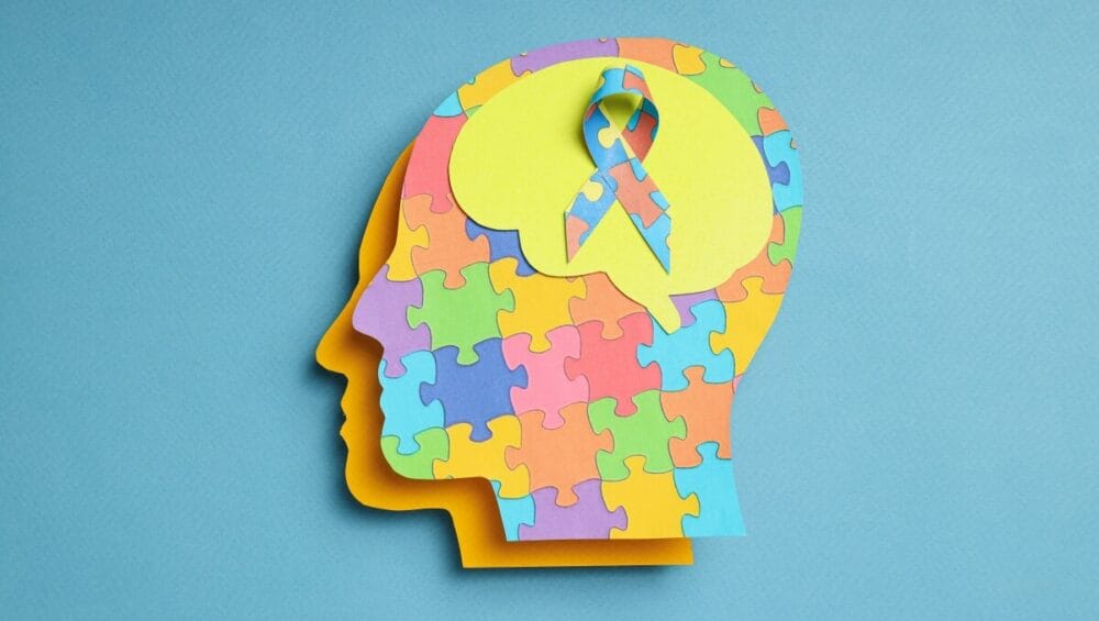 Grafika przedstawia profil głowy z kolorowych puzzli, symbolizująca prewencję w chorobach neurologicznych.